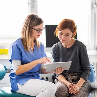 a dentist explaining the cost of sleep apnea treatment