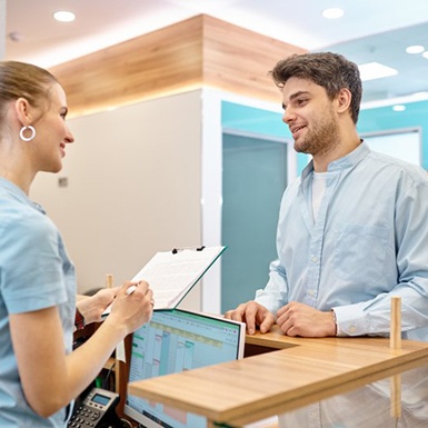 a patient speaking to a front desk member