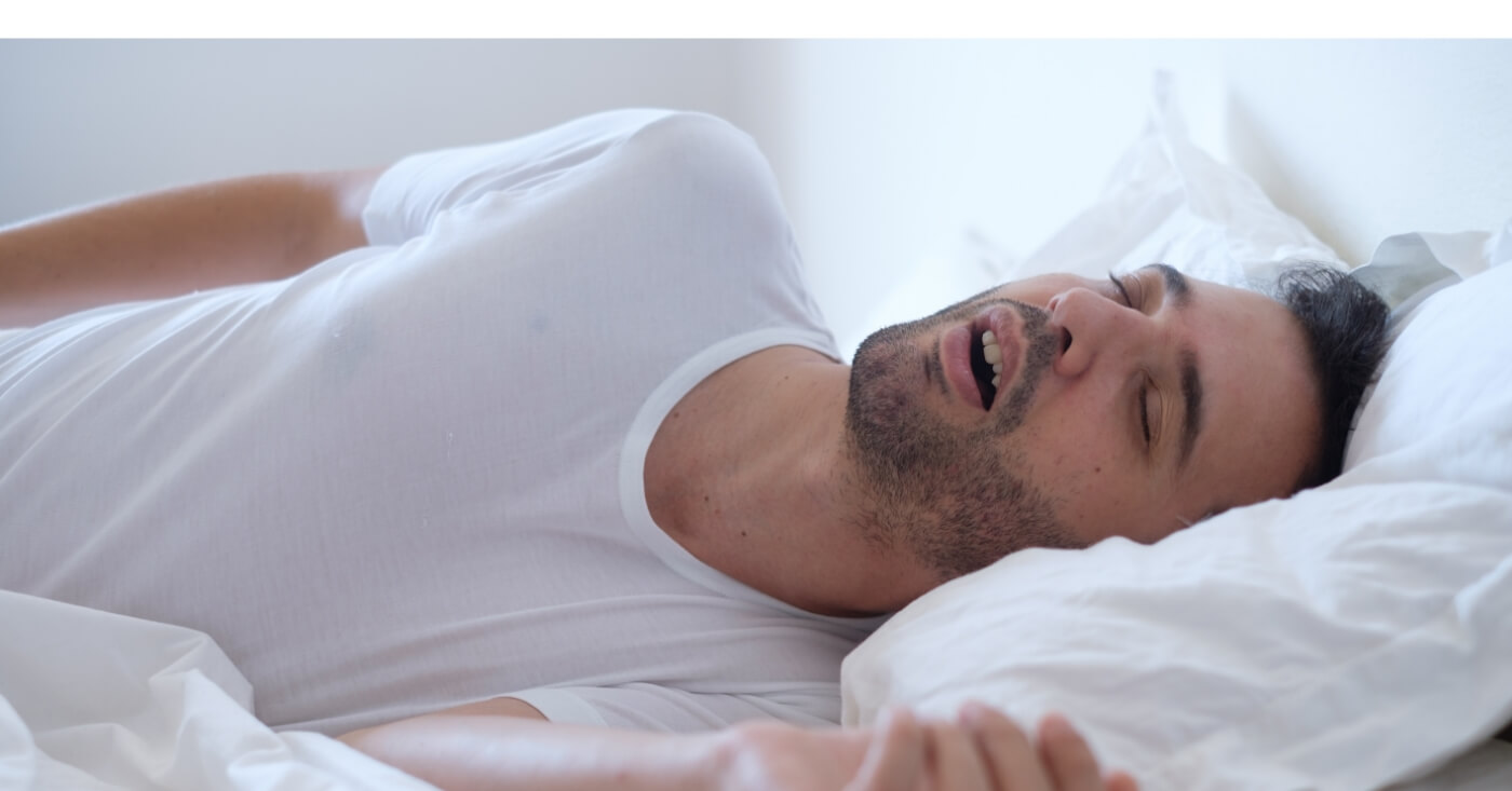 Man sleeping soundly thanks to sleep apnea treatment
