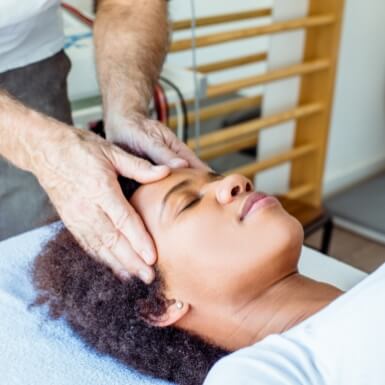 Dentist examining dental patient experiencing headaches