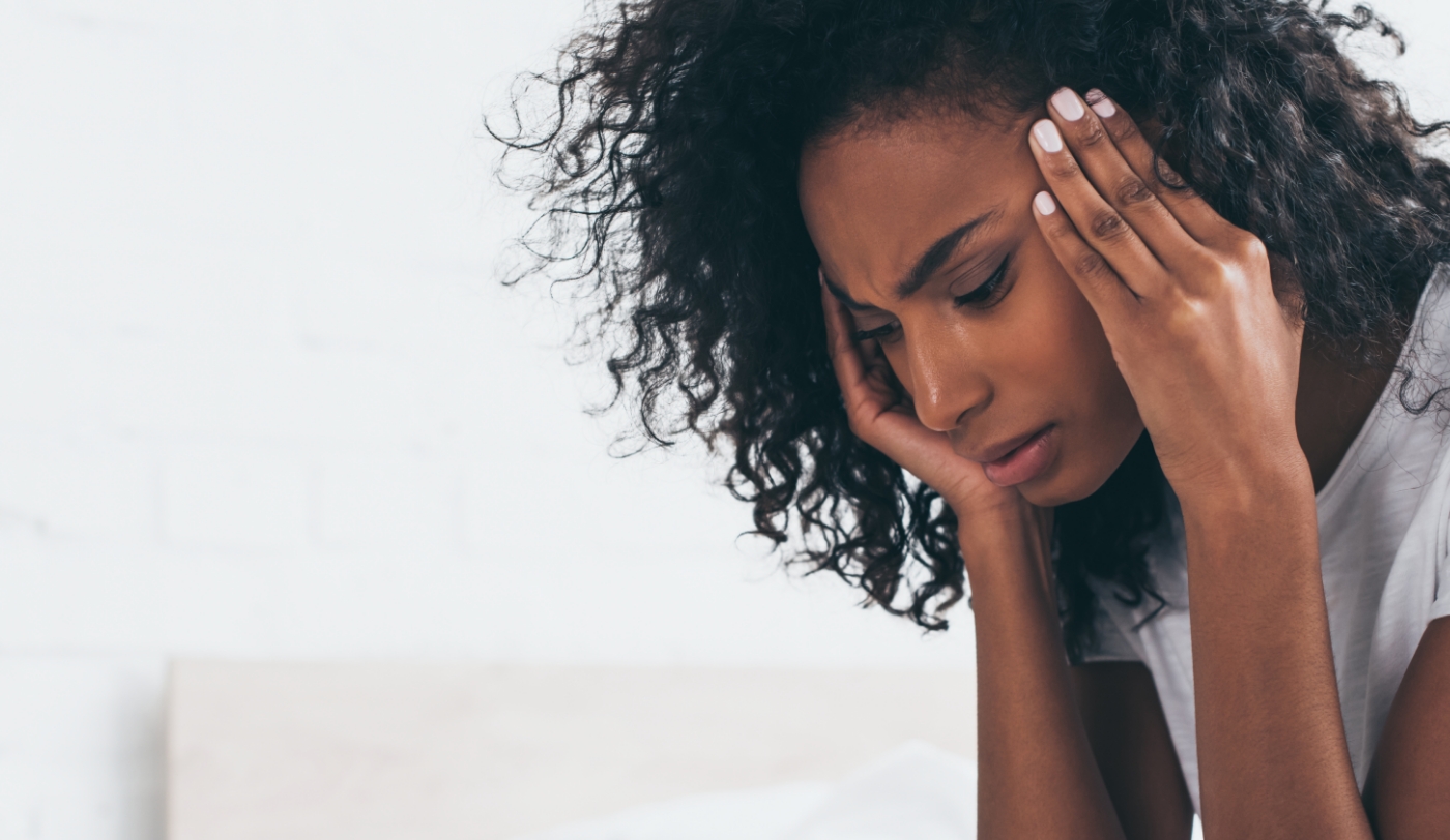 Woman with a migraine holding her head