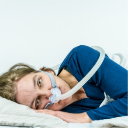 Frustrated person cannot sleep with CPAP