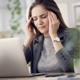 Woman with headache holding her temples