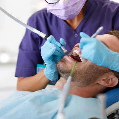 Dentist examining dental patient to diagnose T M J disorder