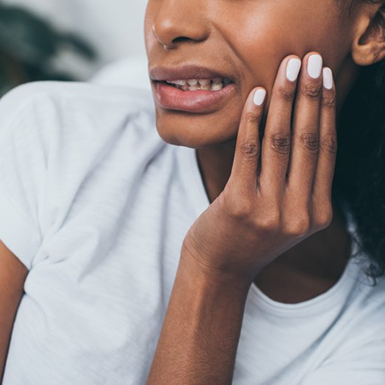 a woman holding her jaw