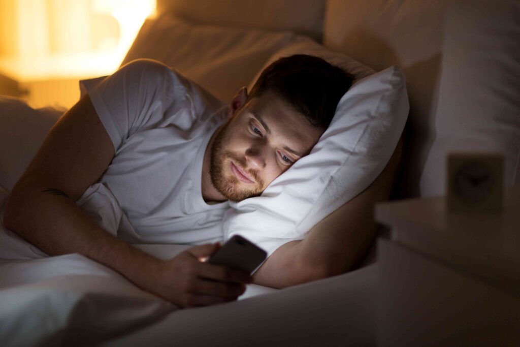 Man on his phone in bed