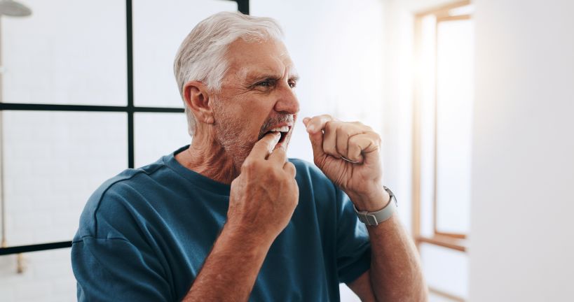 A man flossing his teeth.