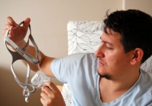 Man frowning at his CPAP mask