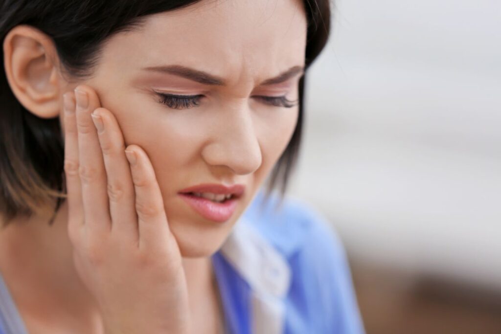 A woman with TMJ disorder pain